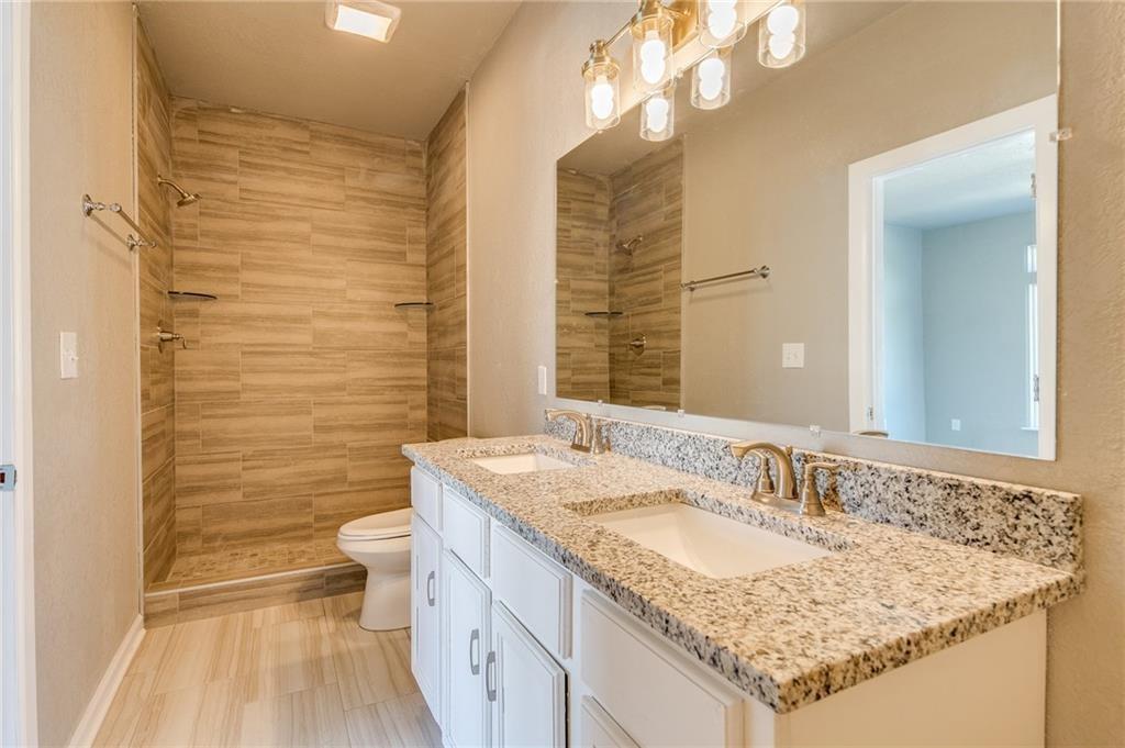 Image 2: Bathroom with double vanity and a stall shower