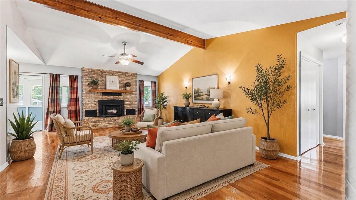 Image 2: Vaulted ceilings with exposed wood beams, brick fi
