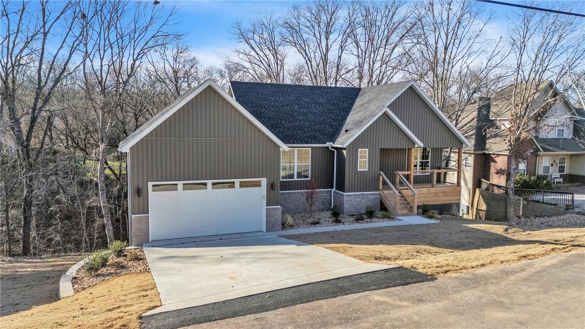 Image 1: View of front of property featuring driveway, a ga