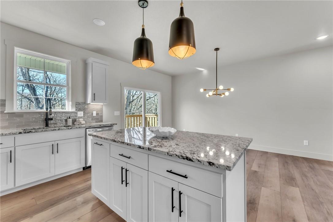 Image 3: Kitchen with light stone counters, light wood-styl