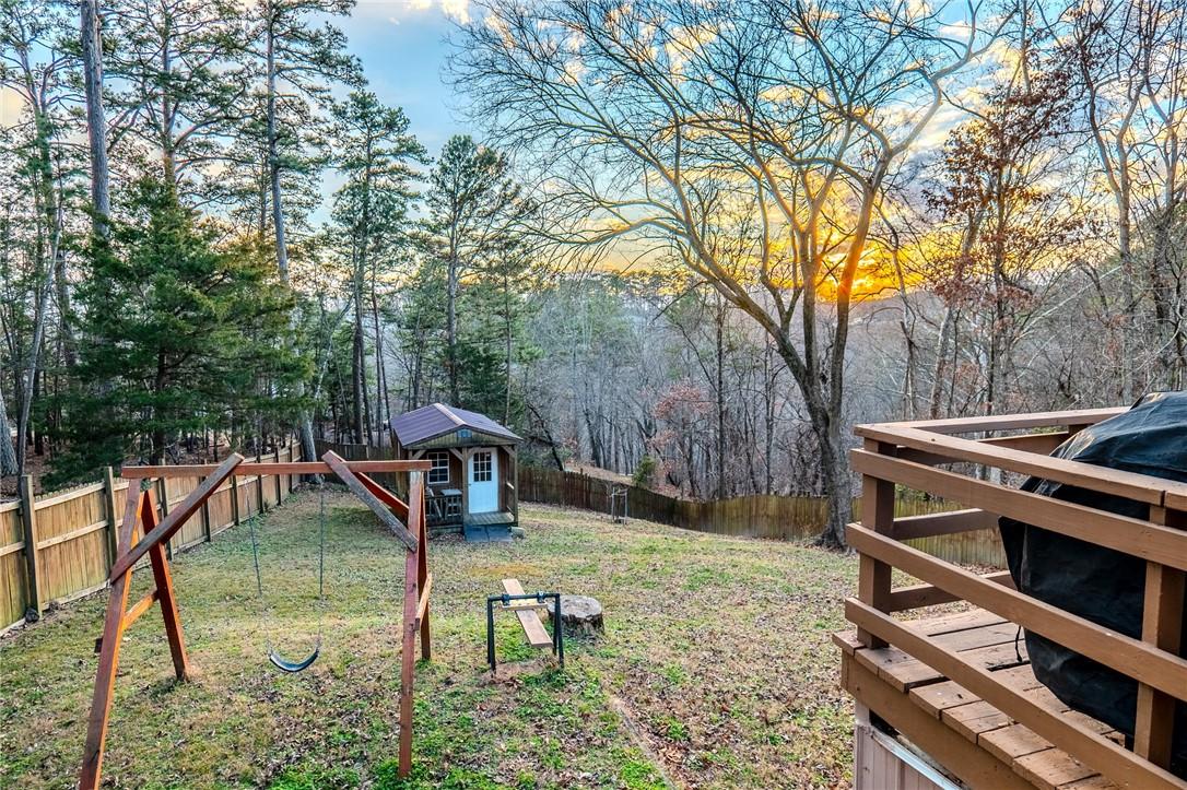 Image 4: Fenced backyard with an outbuilding