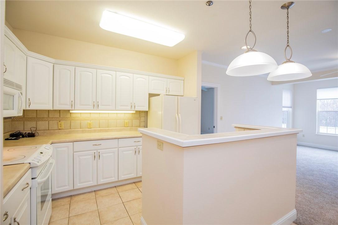 Image 3: Kitchen with white appliances, pendant lighting, w