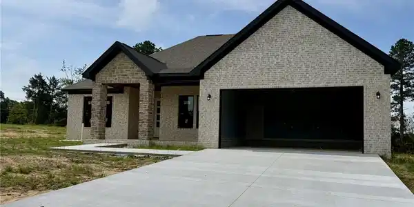 Image 2: Contemporary brick facade with stone accents, a de