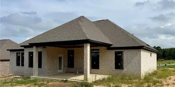 Image 3: Rear exterior showcasing light-colored brick facad