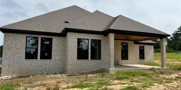 Image 4: New construction home featuring light-toned brick