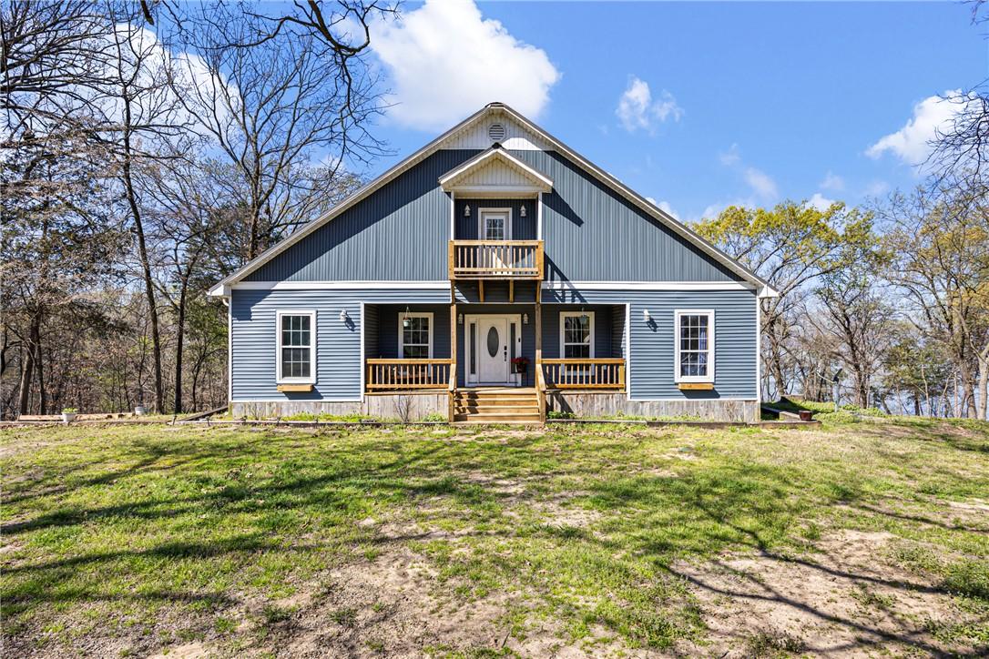 Image 1: View of front facade with a porch, a front lawn, a