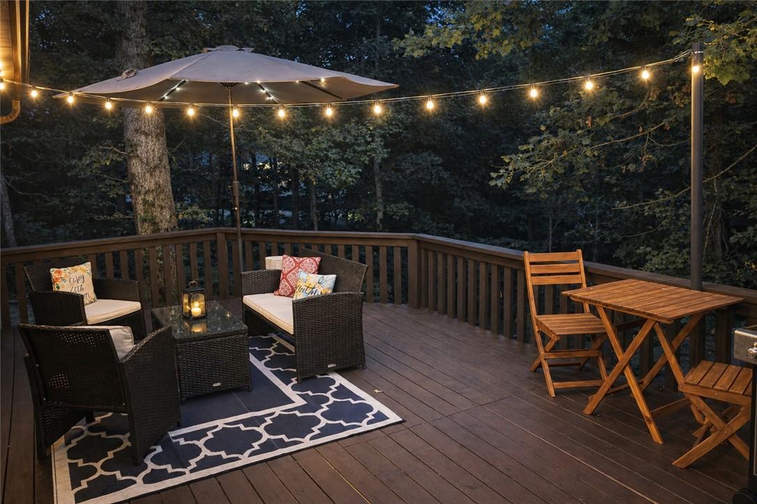 Image 3: Spacious outdoor deck featuring dark wood-finish f