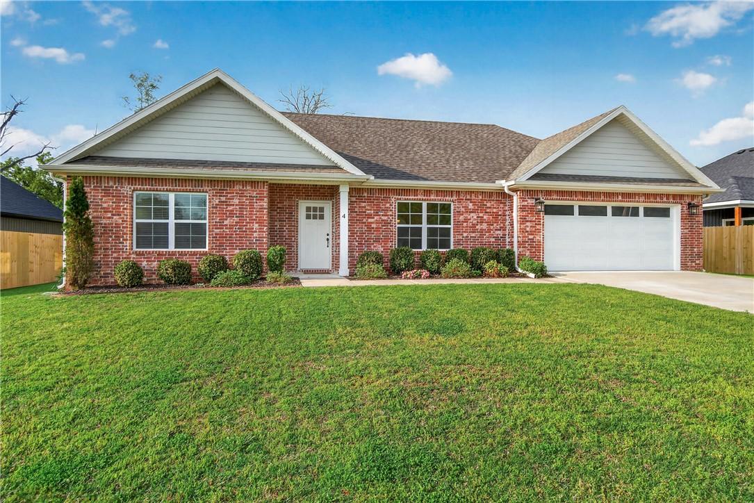 Image 2: Brick exterior with light-colored siding accents a