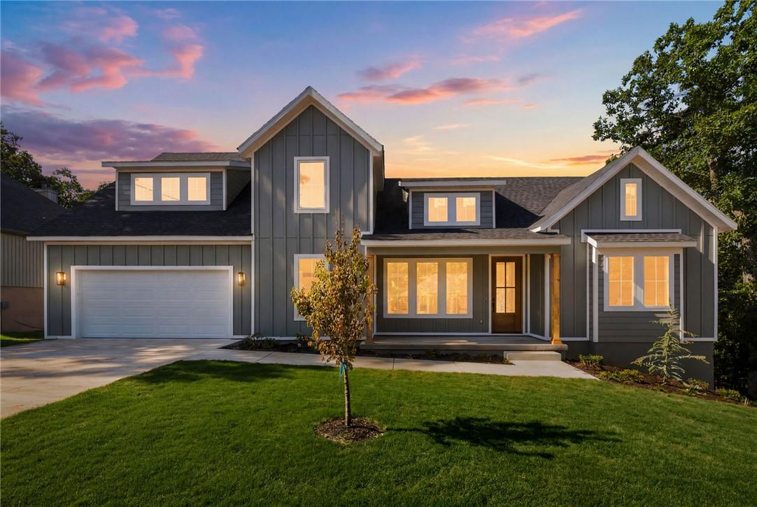 Image 1: Modern farmhouse exterior featuring dark gray vert