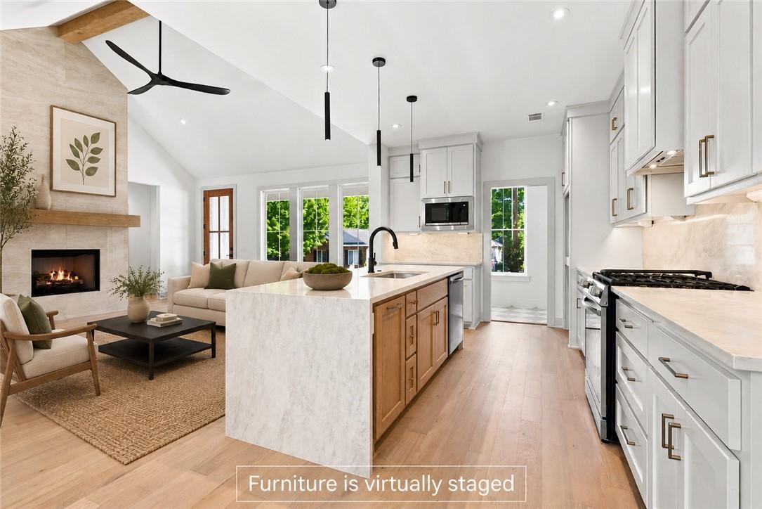 Image 2: Open-concept living space featuring a vaulted ceil