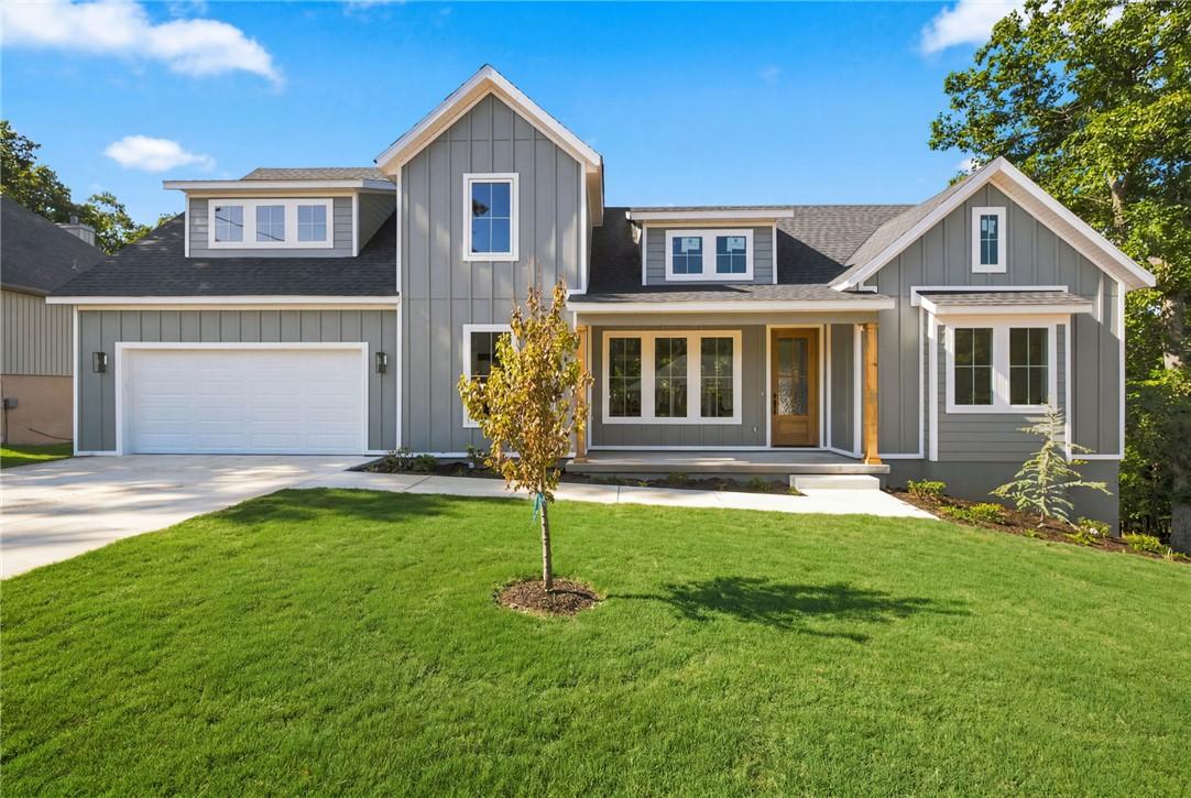 Image 3: Modern farmhouse exterior featuring gray siding, w