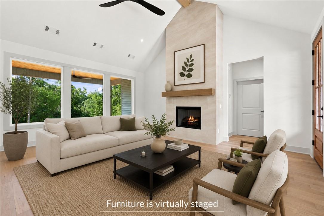 Image 4: Vaulted ceiling living area featuring a prominent