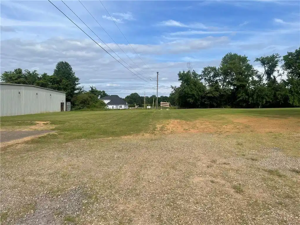 Image 1: Spacious grounds featuring mature landscaping, ope