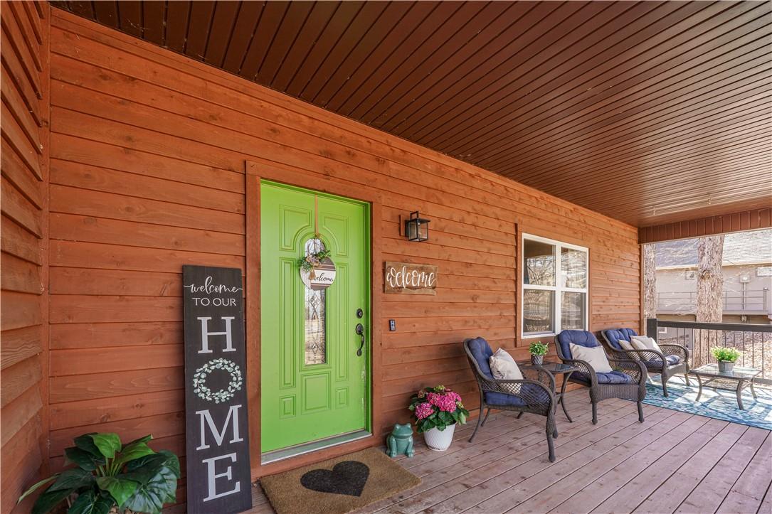 Image 3: Property entrance with a covered porch.  Winter vi