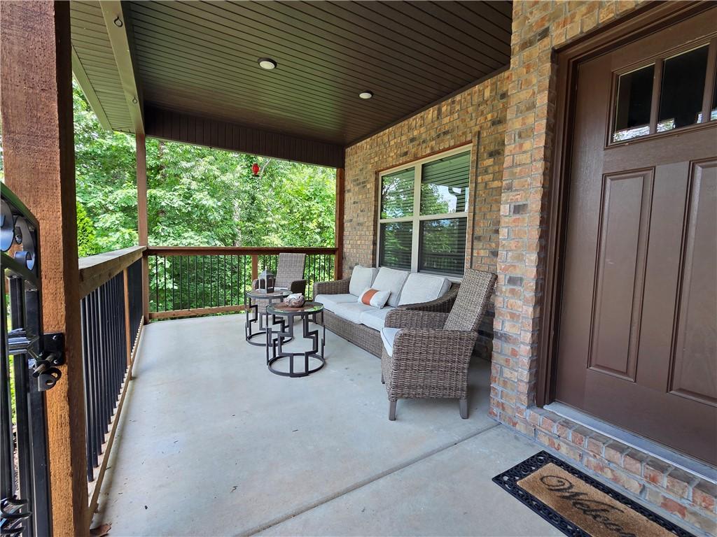 Image 3: Covered porch featuring brick exterior, concrete f