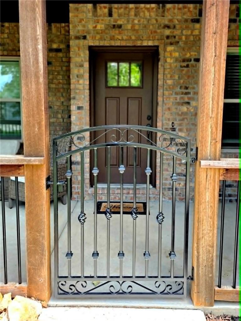 Image 4: Wrought iron gate with decorative scrollwork and t