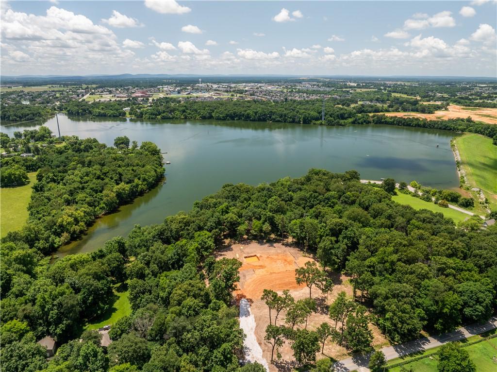 Image 4: Cleared building site featuring partial tree cover