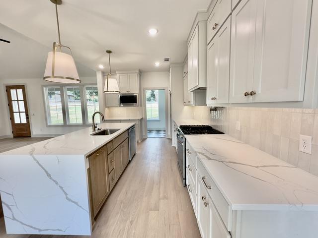 Image 2: Open-concept kitchen featuring an expansive island