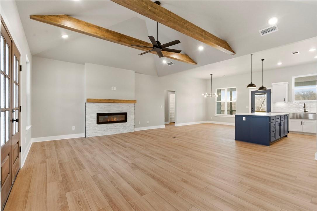 Image 4: Unfurnished living room featuring ceiling fan, a f