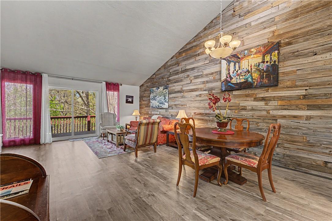 Image 4: Dining area with wood walls, light wood-type floor