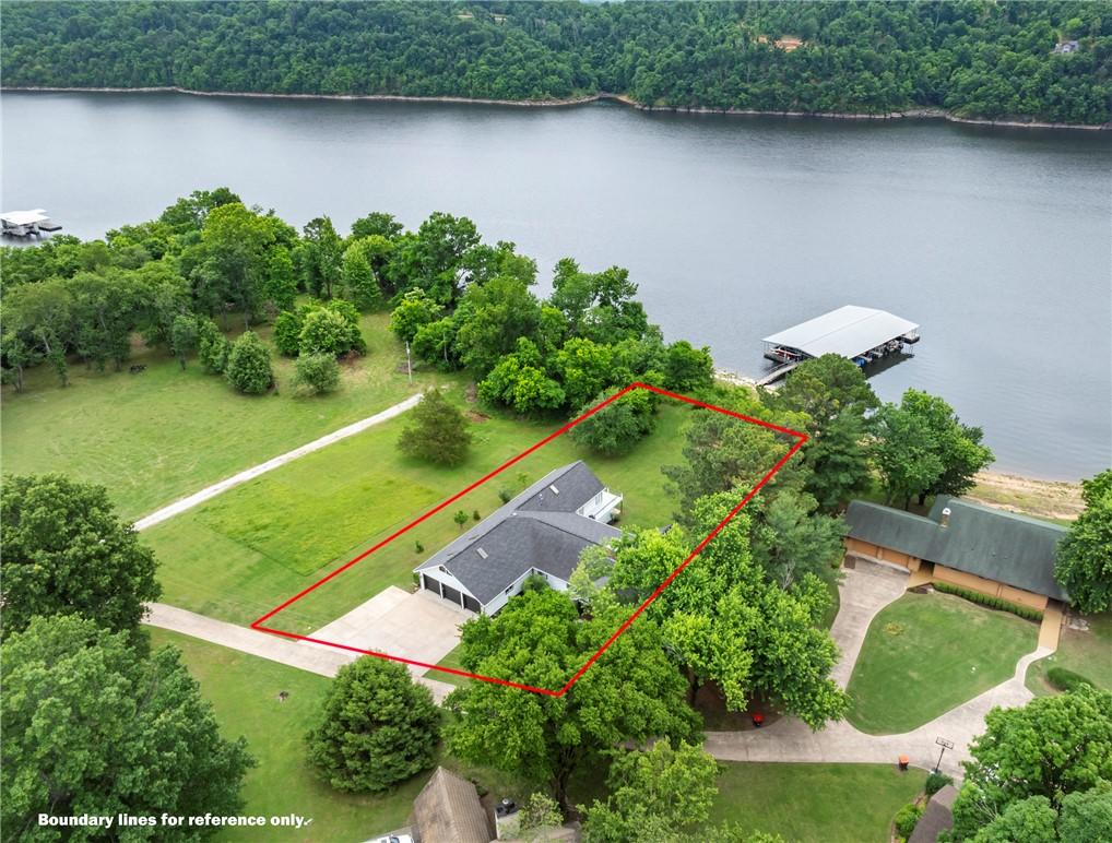 Image 4: Waterfront property featuring a white residence wi