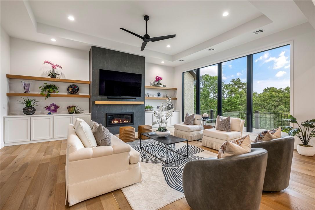 Image 3: Living area featuring expansive floor-to-ceiling w