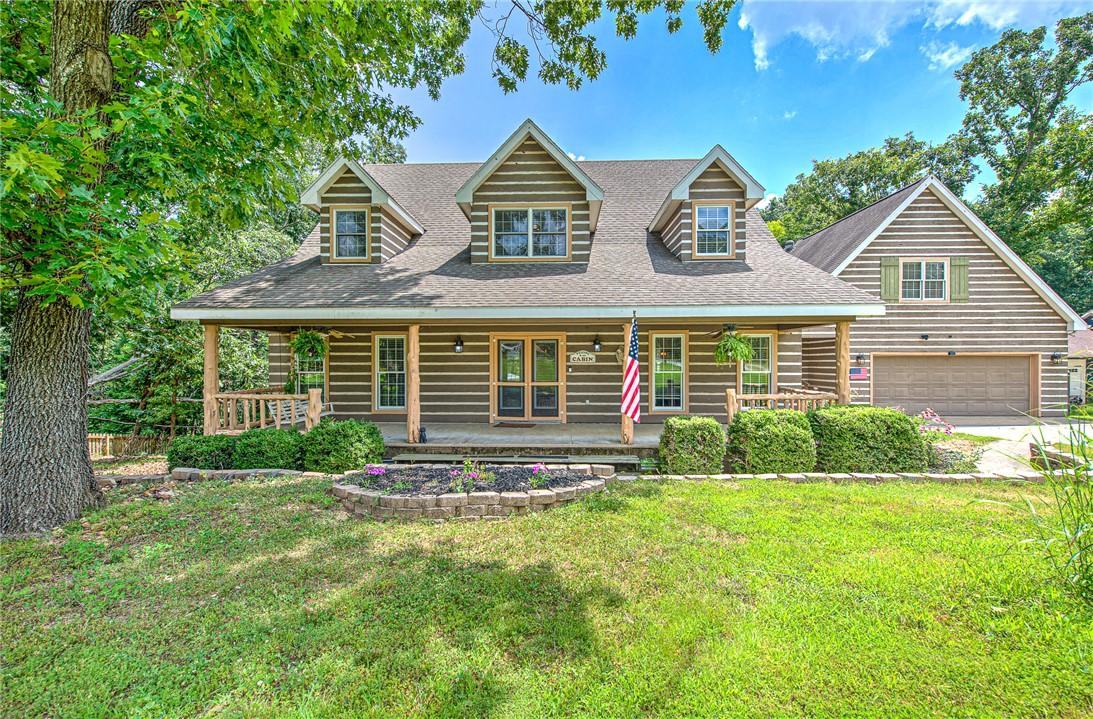Image 2: Log-style siding exterior with a covered porch, do