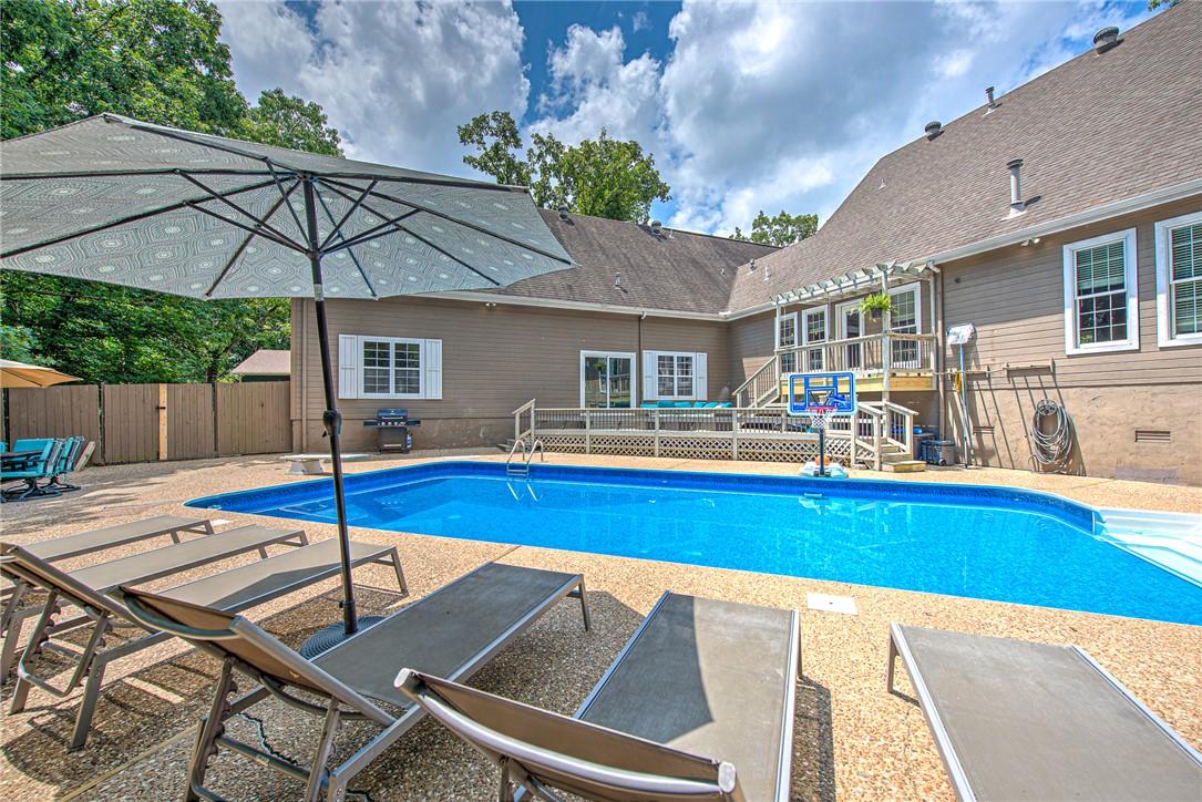 Image 3: Outdoor swimming pool with a surrounding textured