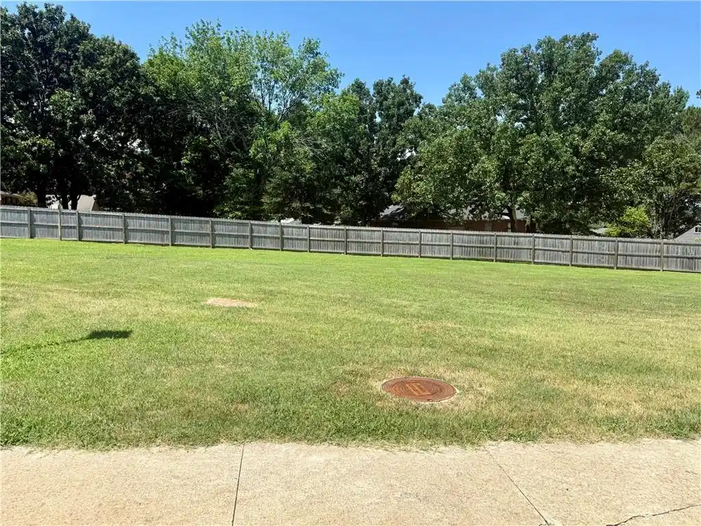 Image 1: Expansive lawn area with a solid wood privacy fenc