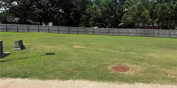 Image 2: Expansive grassy lot featuring mature perimeter tr
