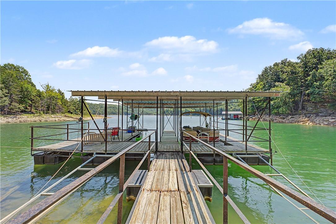 Image 2: Floating dock with two covered slips, a wooden wal
