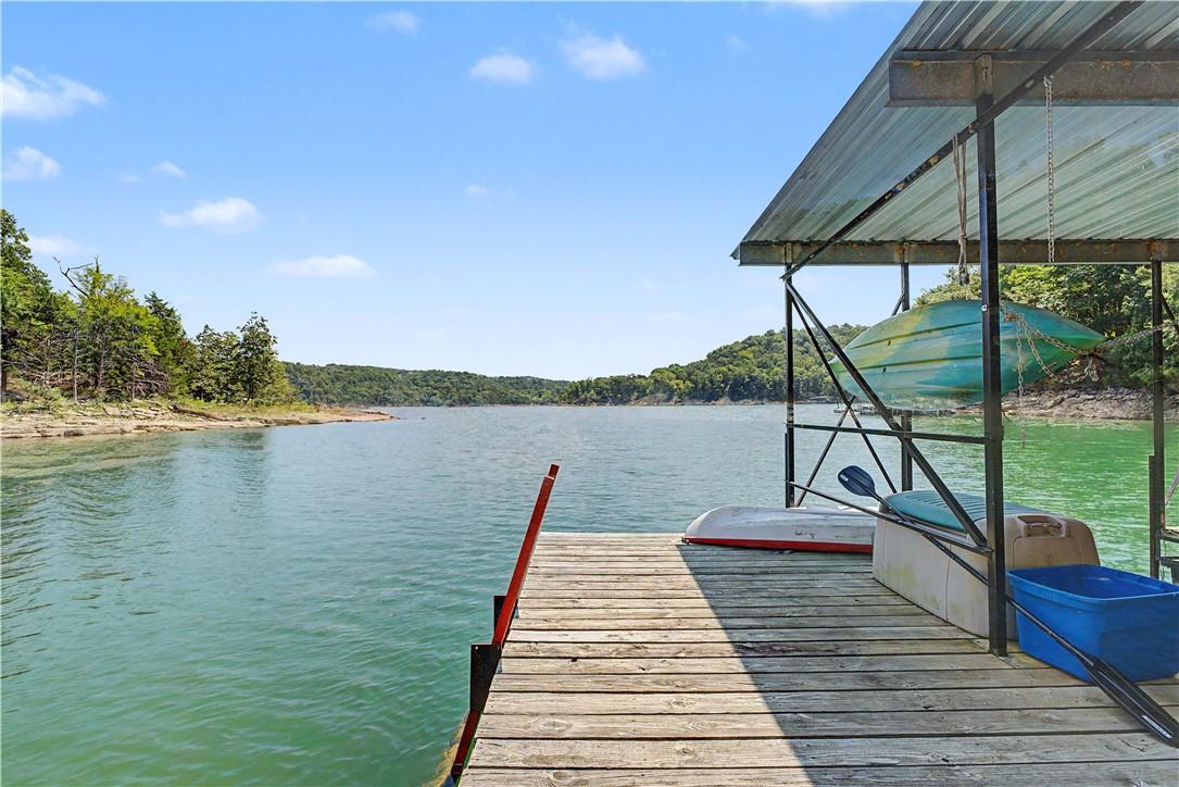 Image 3: Wooden dock with a metal-framed boat slip and a me