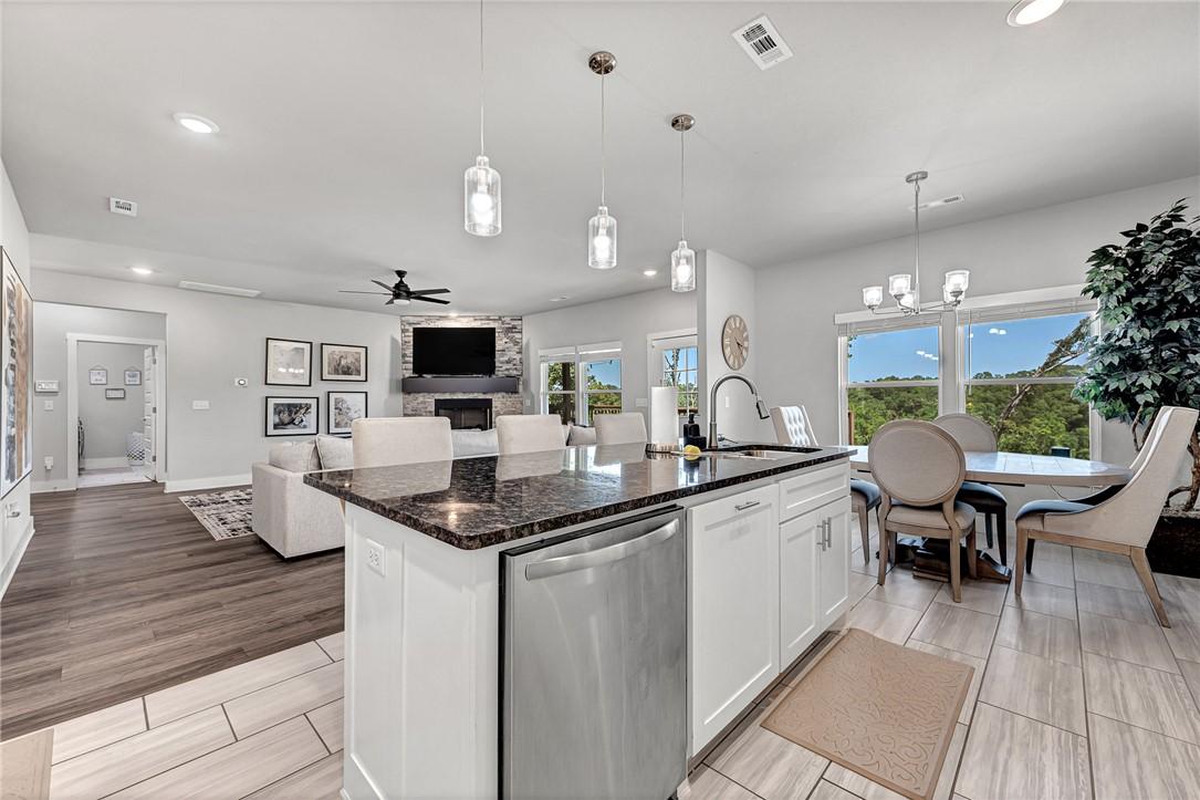 Image 4: Kitchen featuring white cabinets, stainless steel