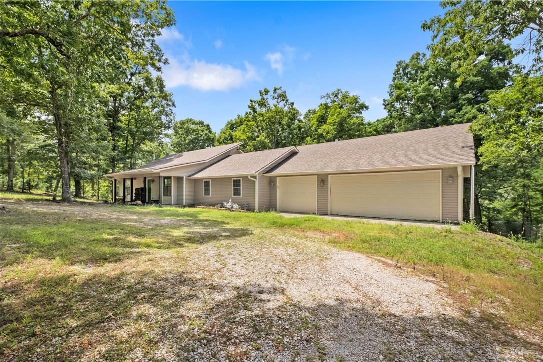 Image 3: Ranch-style residence featuring a gravel driveway,