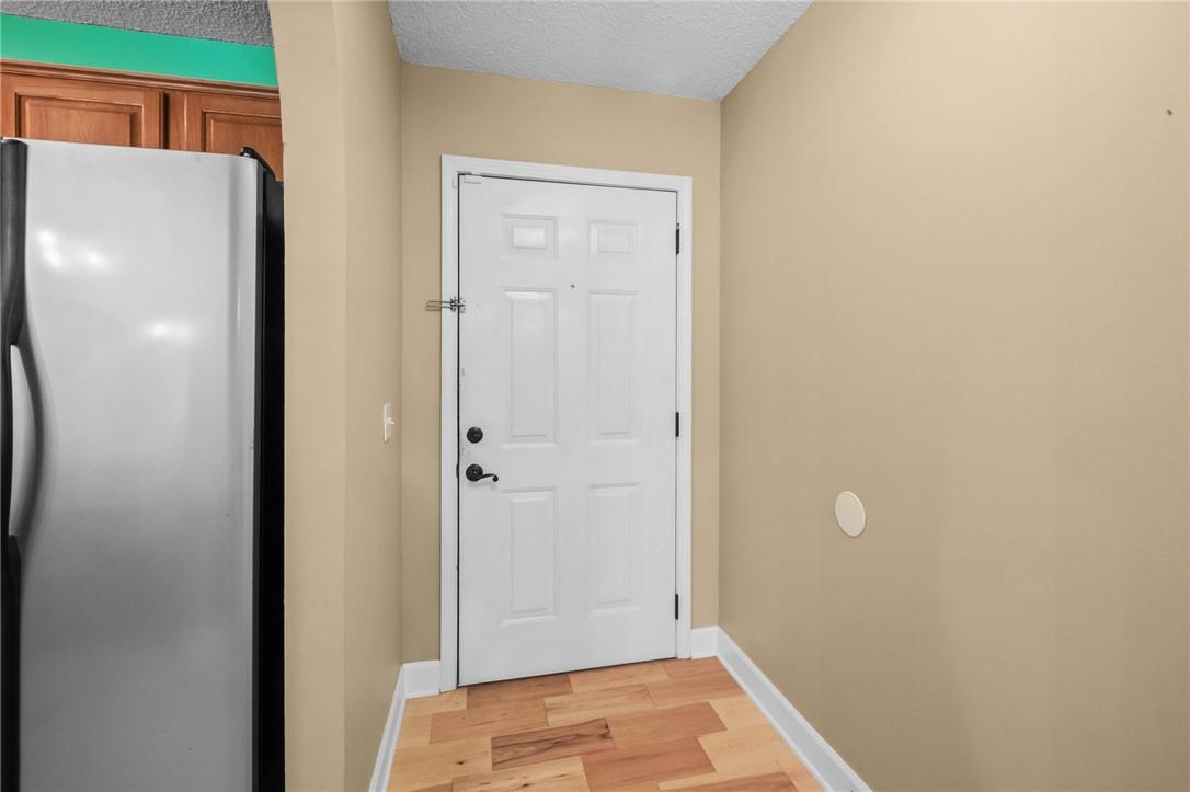 Image 4: Entryway featuring a white paneled door with matte