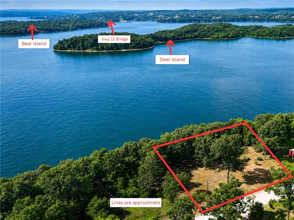 Image 1: Wooded lot offering waterfront proximity with lake