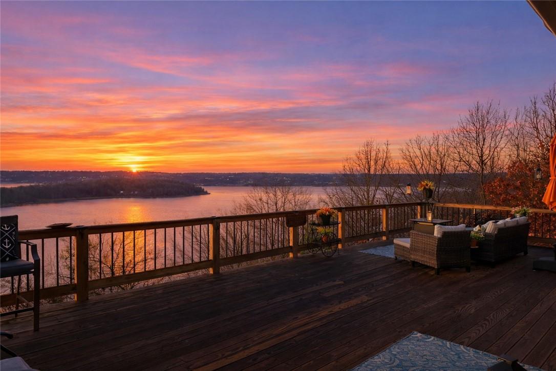 Image 3: Wooden deck with a water view and outdoor lounge a