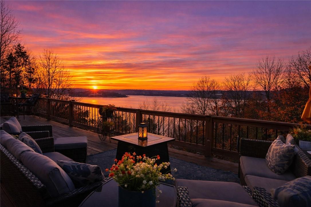 Image 4: Deck at dusk with an outdoor living space and a la