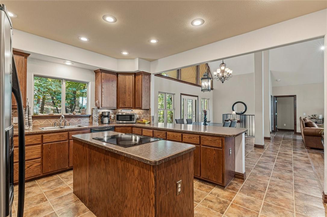 Image 4: The spacious kitchen features a central island and
