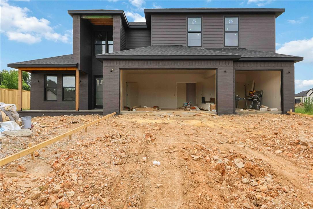 Image 1: Contemporary exterior featuring dark brick and hor