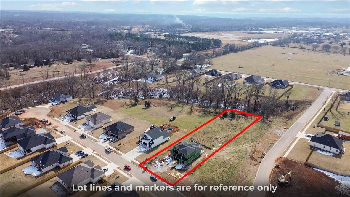 Image 2: Cleared residential lot within a developing commun