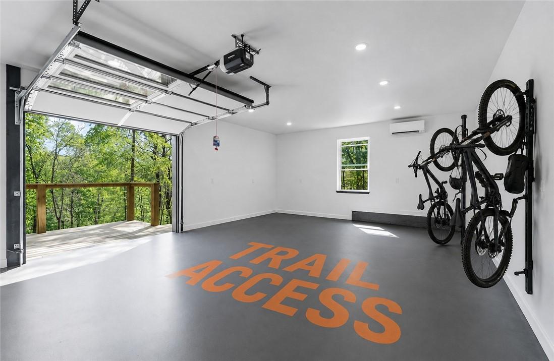 Image 1: Spacious garage with an overhead glass-paneled doo