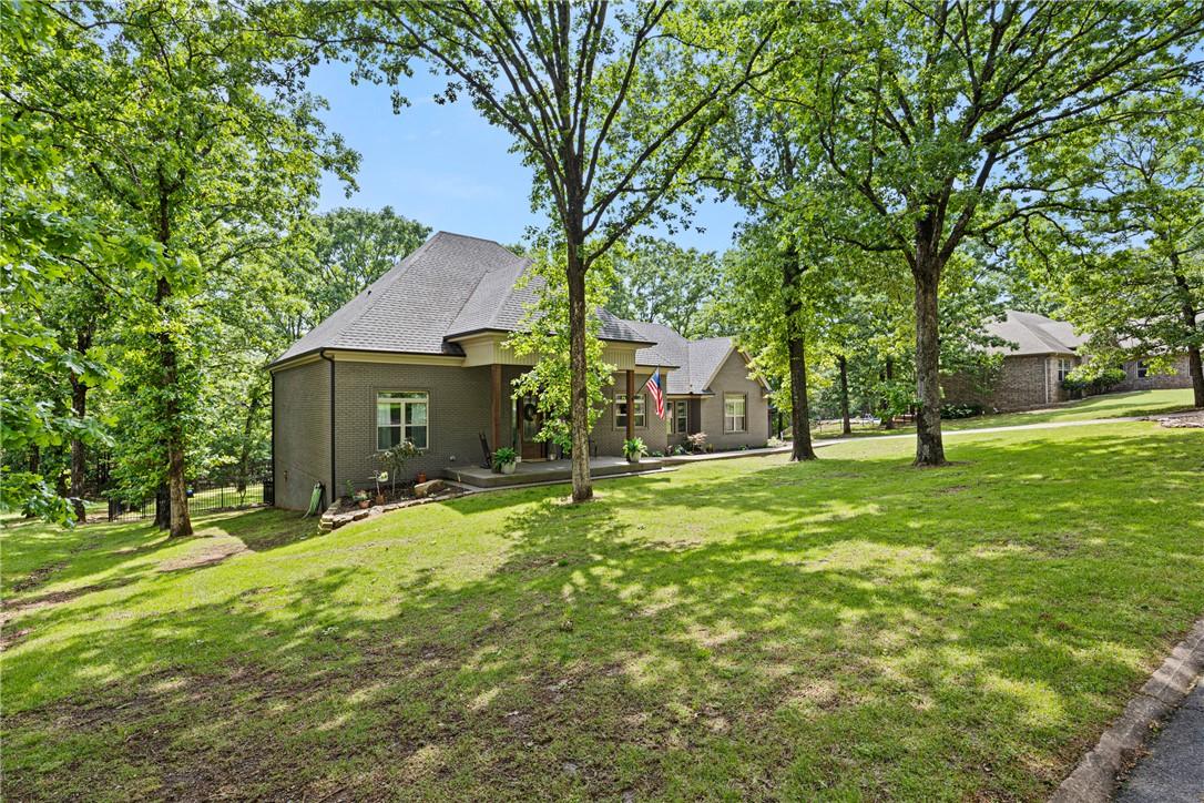 Image 1: Stone-clad residence featuring a gabled roofline,