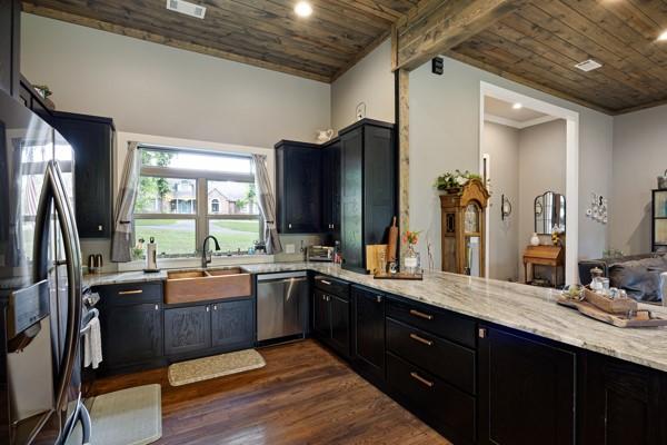 Image 4: Kitchen featuring wood-finish flooring, dark cabin