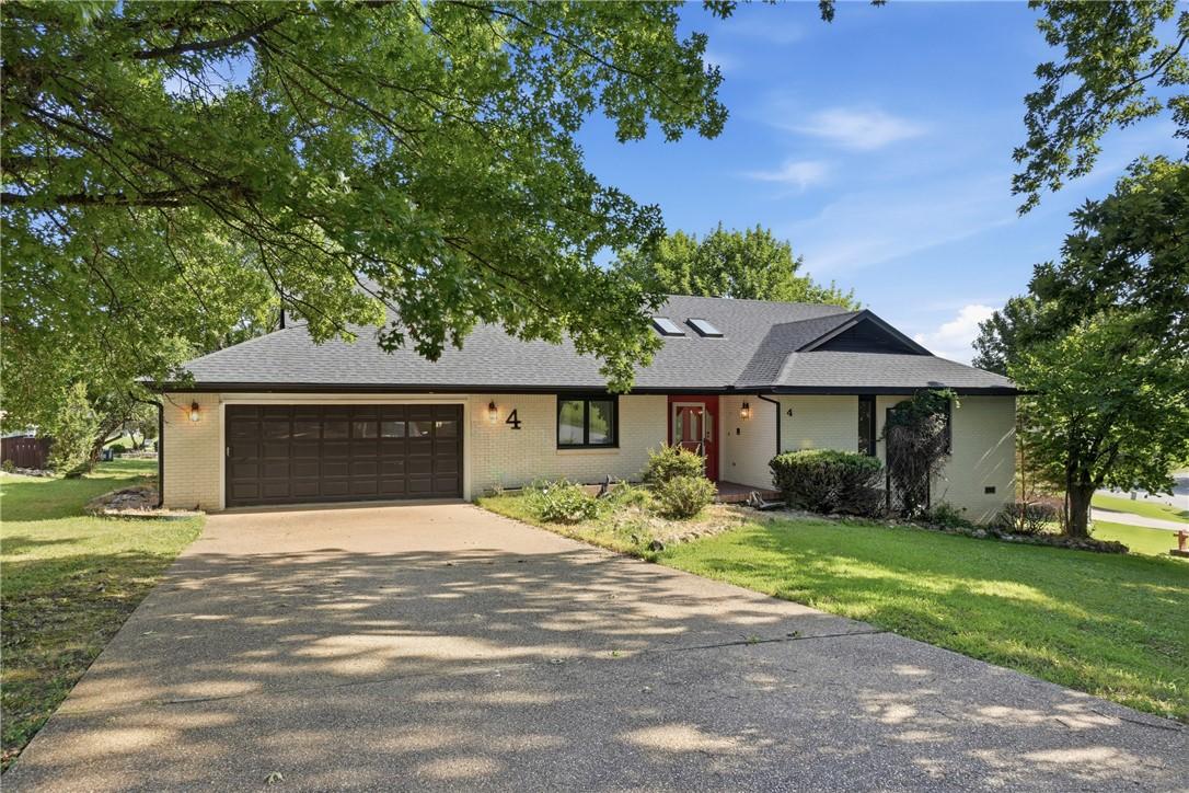 Image 1: Ranch-style residence featuring a prominent two-ca