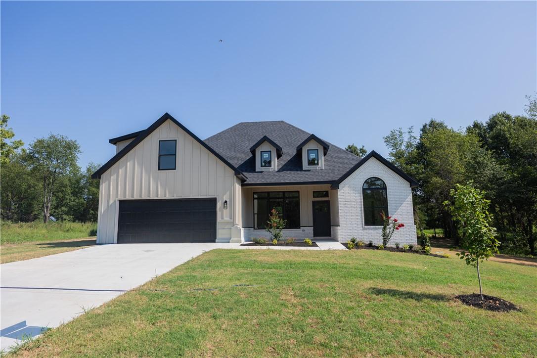 Image 2: Modern farmhouse-style exterior featuring white br