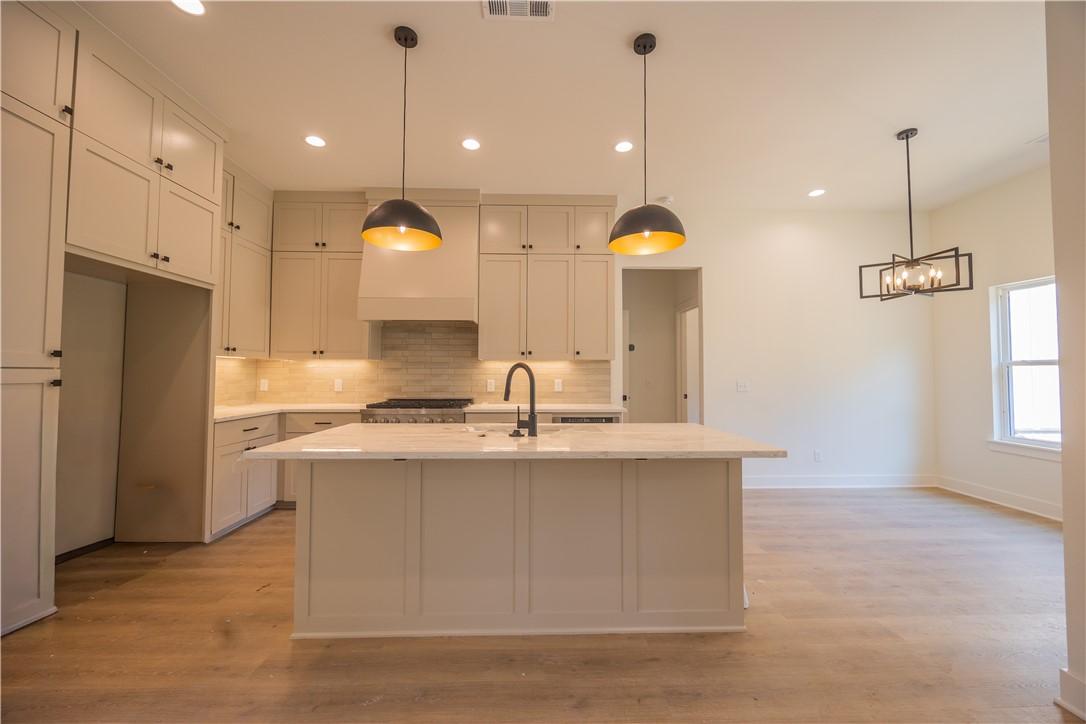Image 3: Spacious kitchen featuring an expansive central is