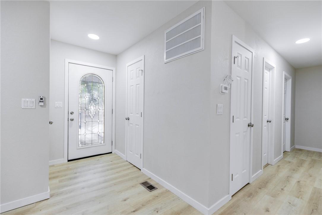 Image 3: Entryway featuring a decorative glass front door,