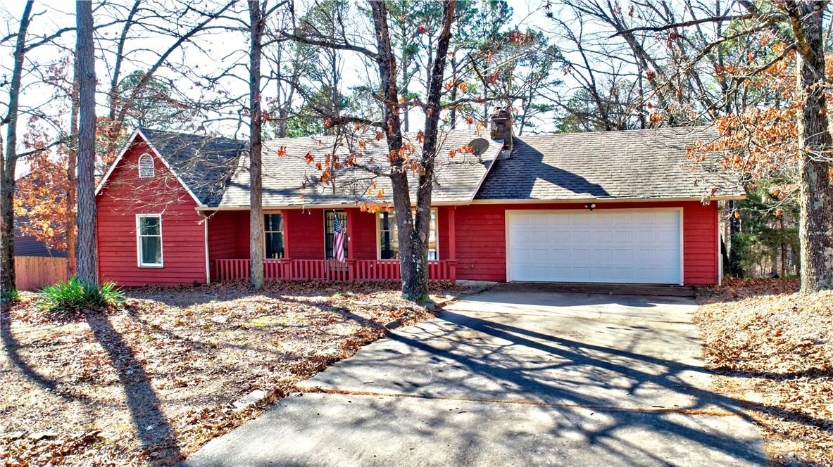 Image 3: View of front of property with concrete driveway,
