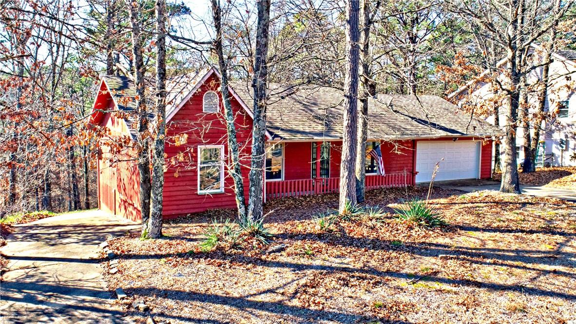 Image 4: Rustic home featuring concrete driveway, a garage,